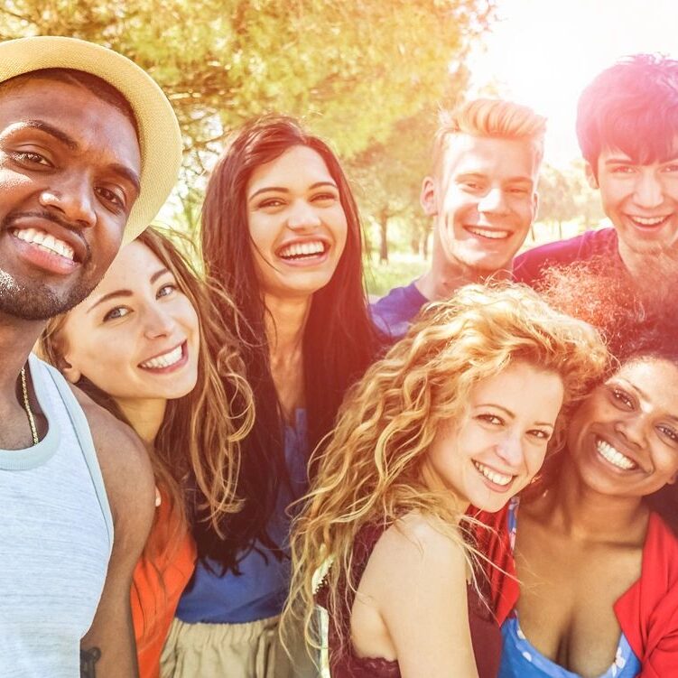 A group of people that are smiling for the camera